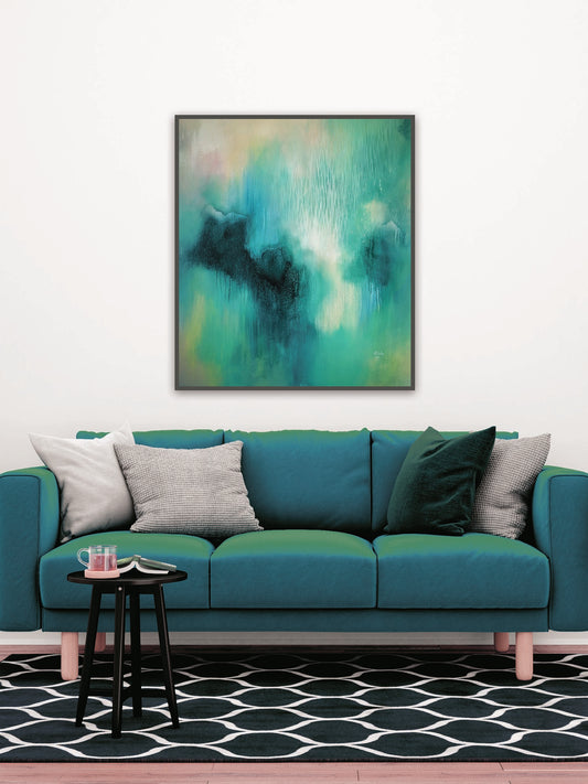 Turquoise sofa with decorative pillows in a room with a green abstract painting on the wall.
