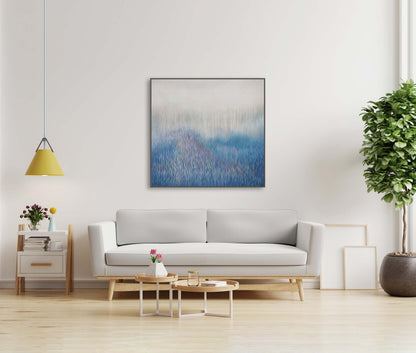 Modern living room with a gray sofa, abstract painting, and decorative elements.