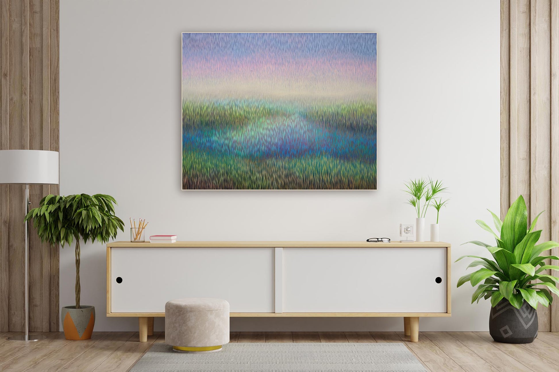Modern living room with a painting of a landscape on the wall, a white console table, and decorative plants.