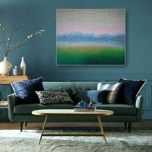 Living room with a green sofa, abstract painting, and decorative items.
