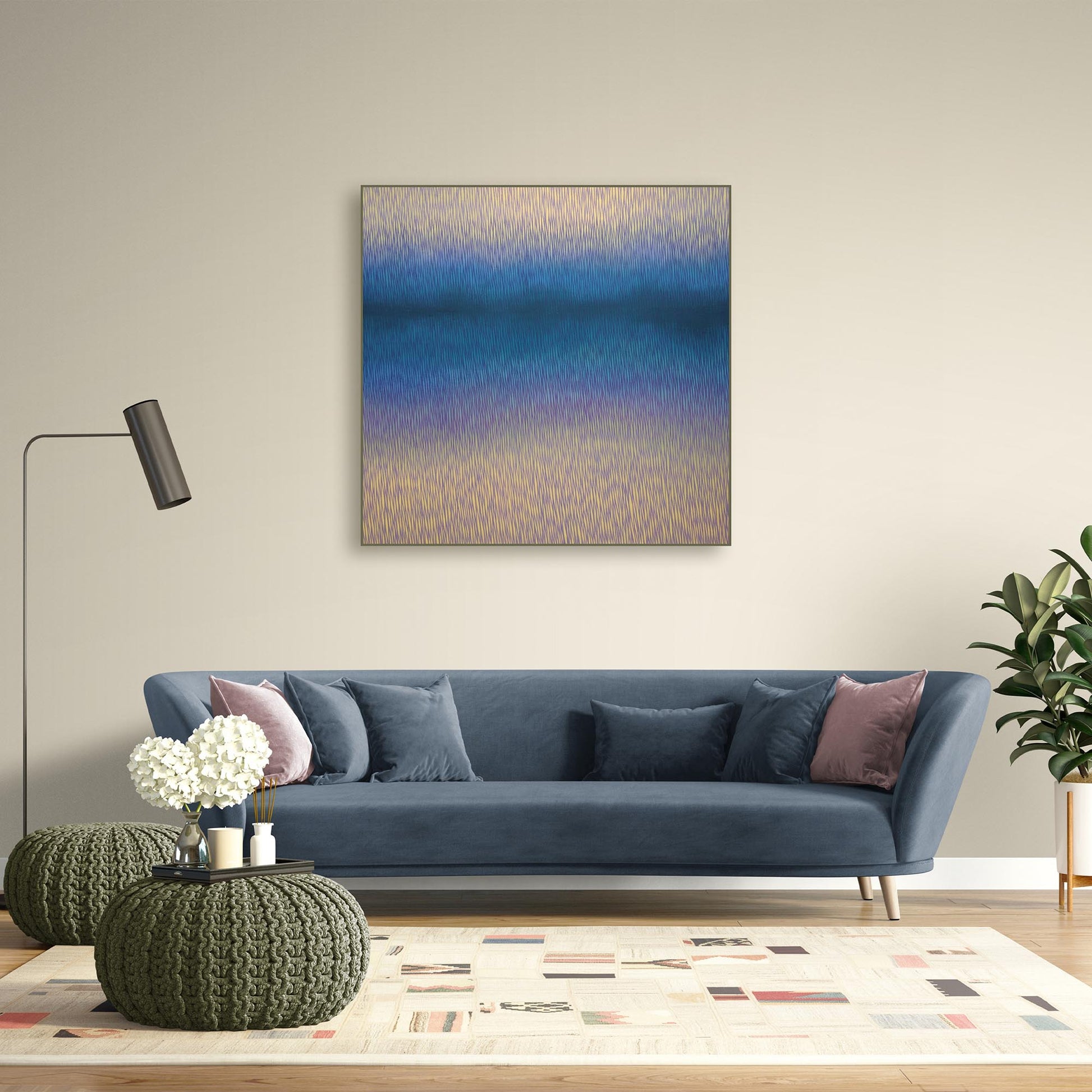 Modern living room with a painting of a landscape on the wall, a white console table, and decorative plants.