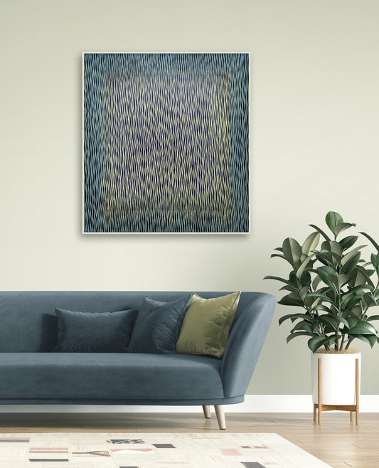 Abstract painting on a wall above a blue sofa with decorative pillows and a plant.