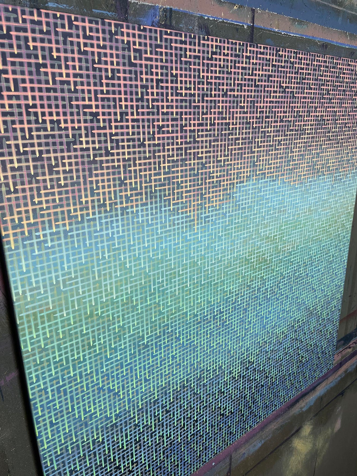 Close-up of a textured artwork surface with a gradient from blue to green.