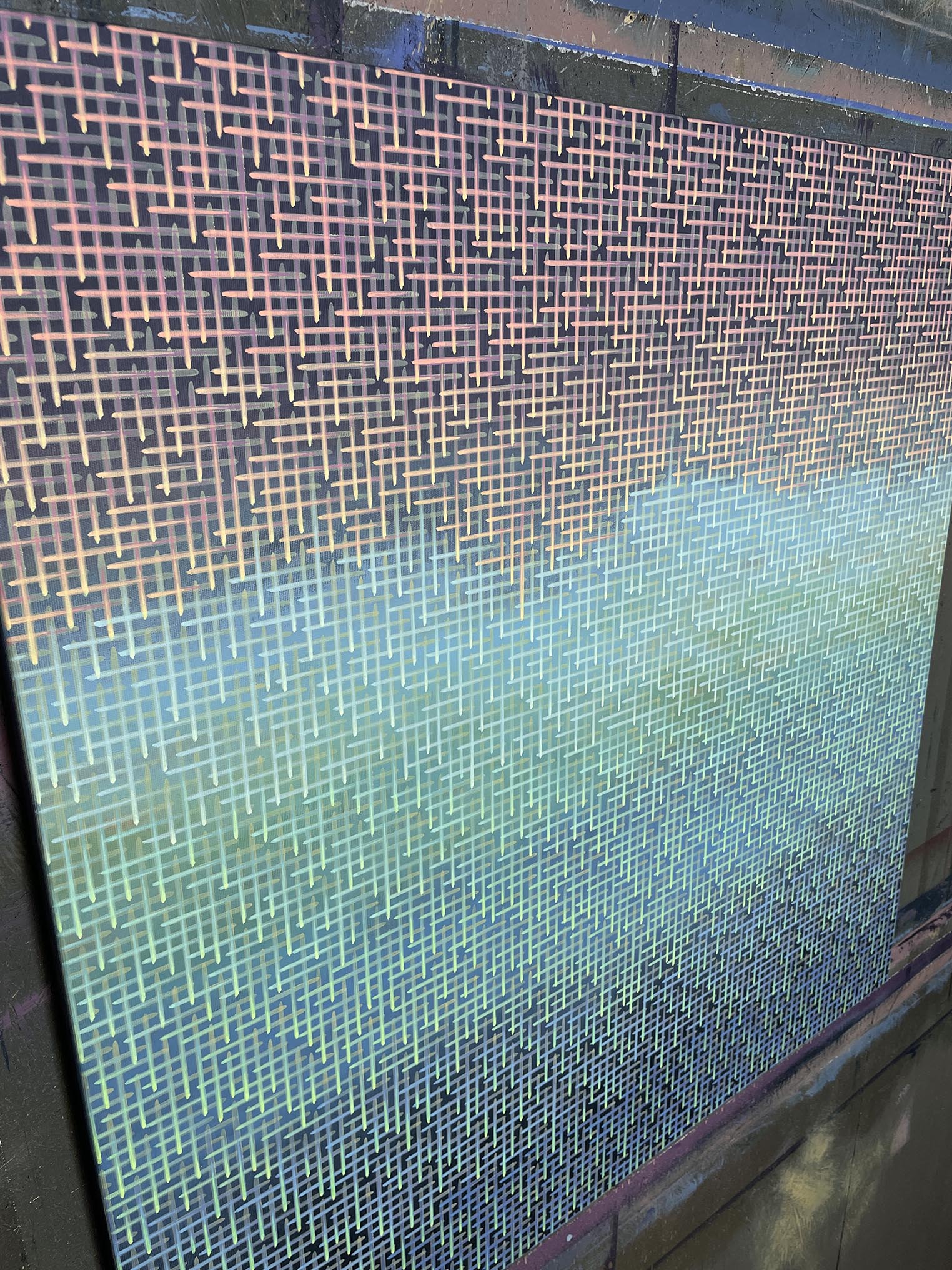 Close-up of a textured artwork surface with a gradient from blue to green.