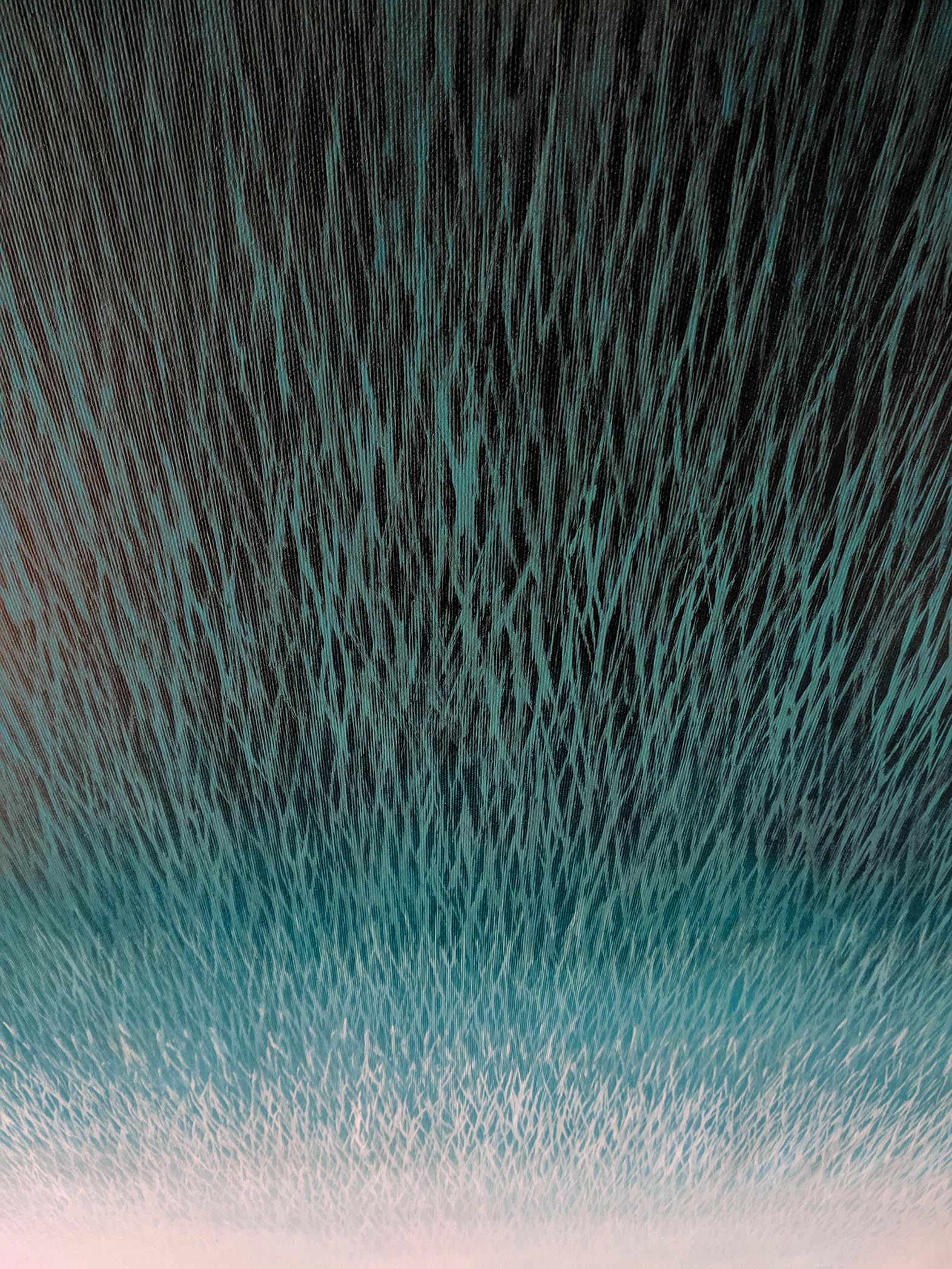 Abstract art with wavy lines in teal, black, and white.