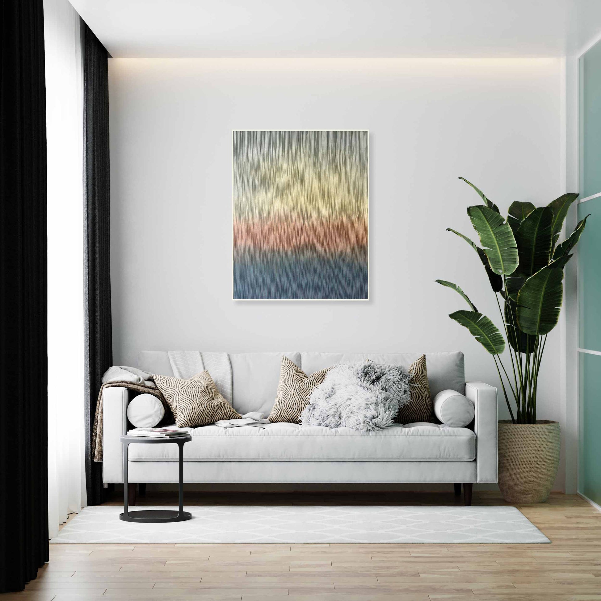 Modern living room with a white sofa, decorative pillows, a plant, and abstract original art on the wall.