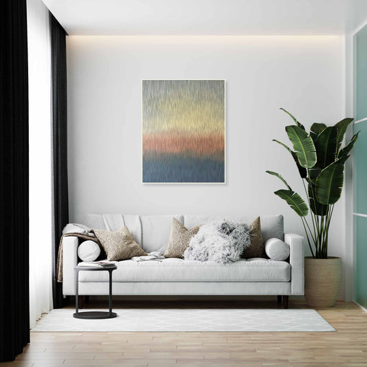 Modern living room with a white sofa, decorative pillows, a plant, and abstract original art on the wall.