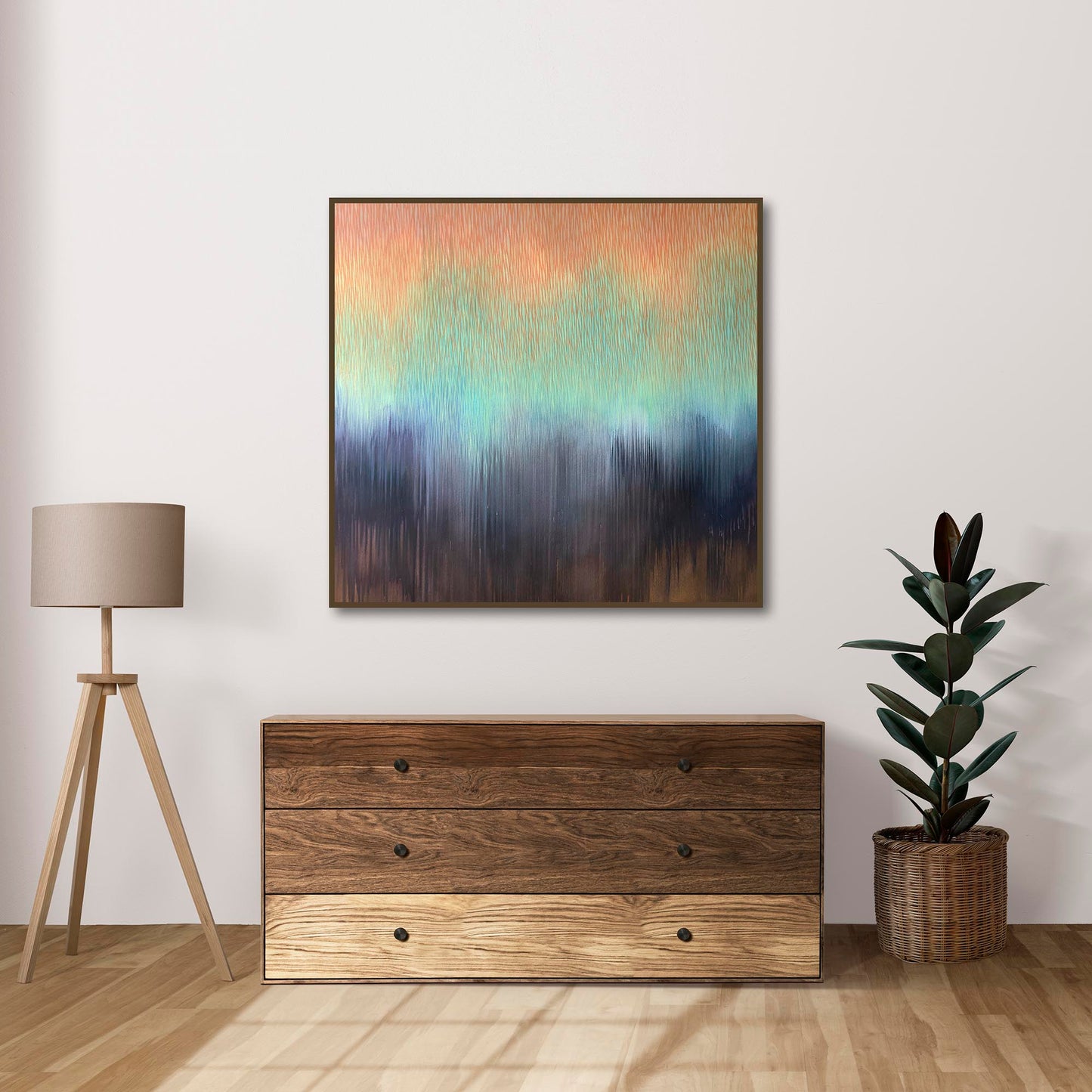 Wooden dresser with abstract painting and plant in a room setting