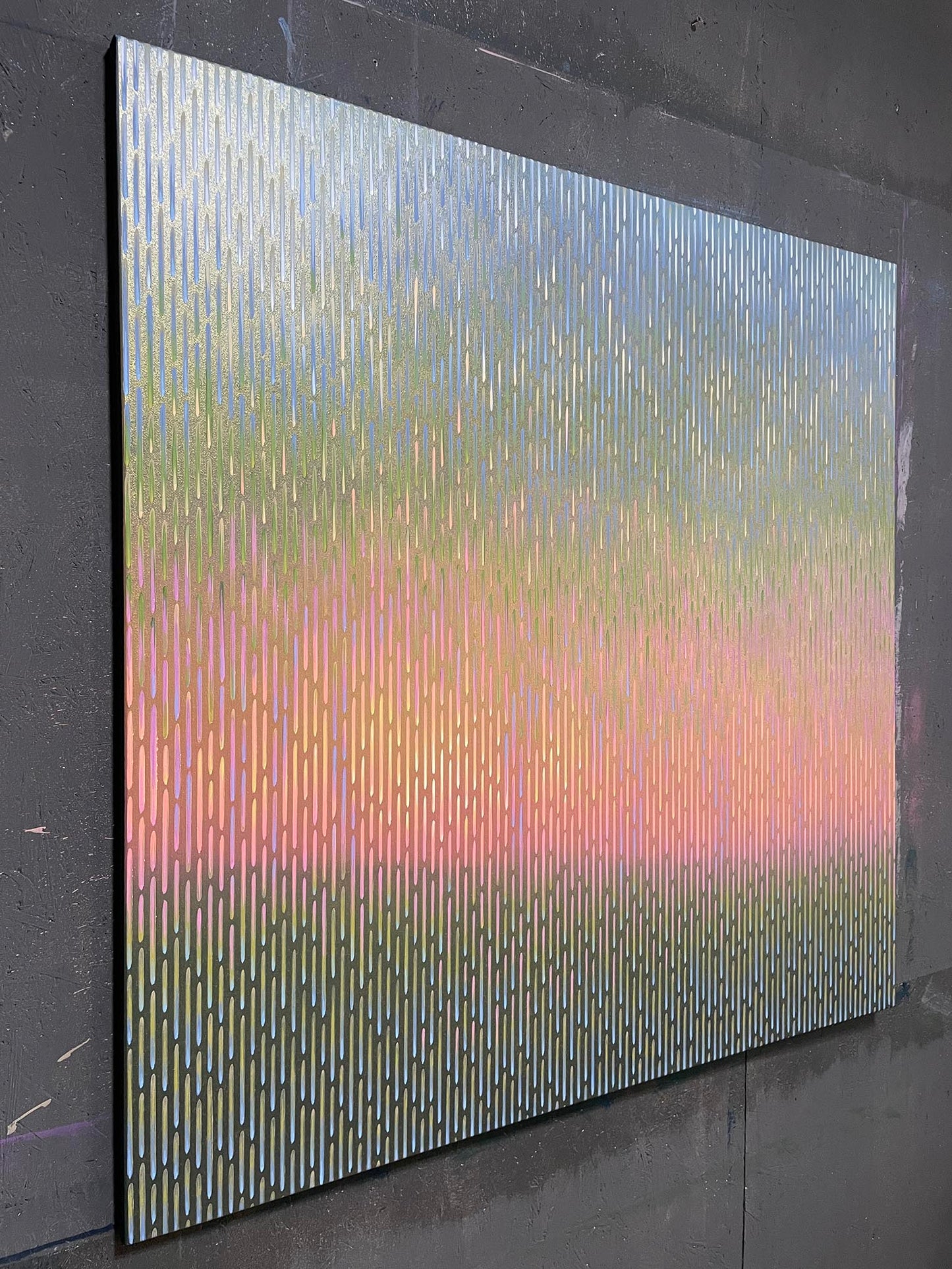 Multicolored abstract art piece on a dark gray wall