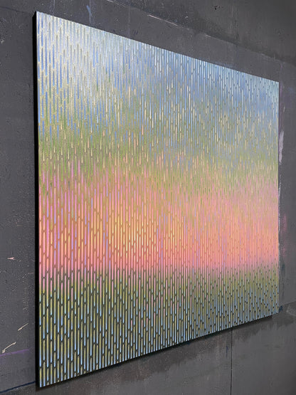 Multicolored abstract art piece on a dark gray wall