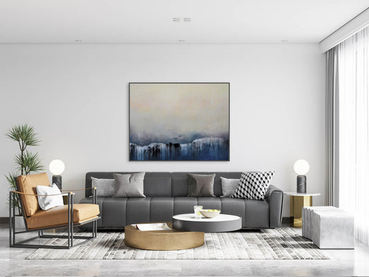Modern living room with gray sofa, brown armchair, and abstract painting on wall.