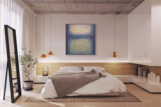 Modern bedroom with a bed, artwork on the wall, and decorative elements.