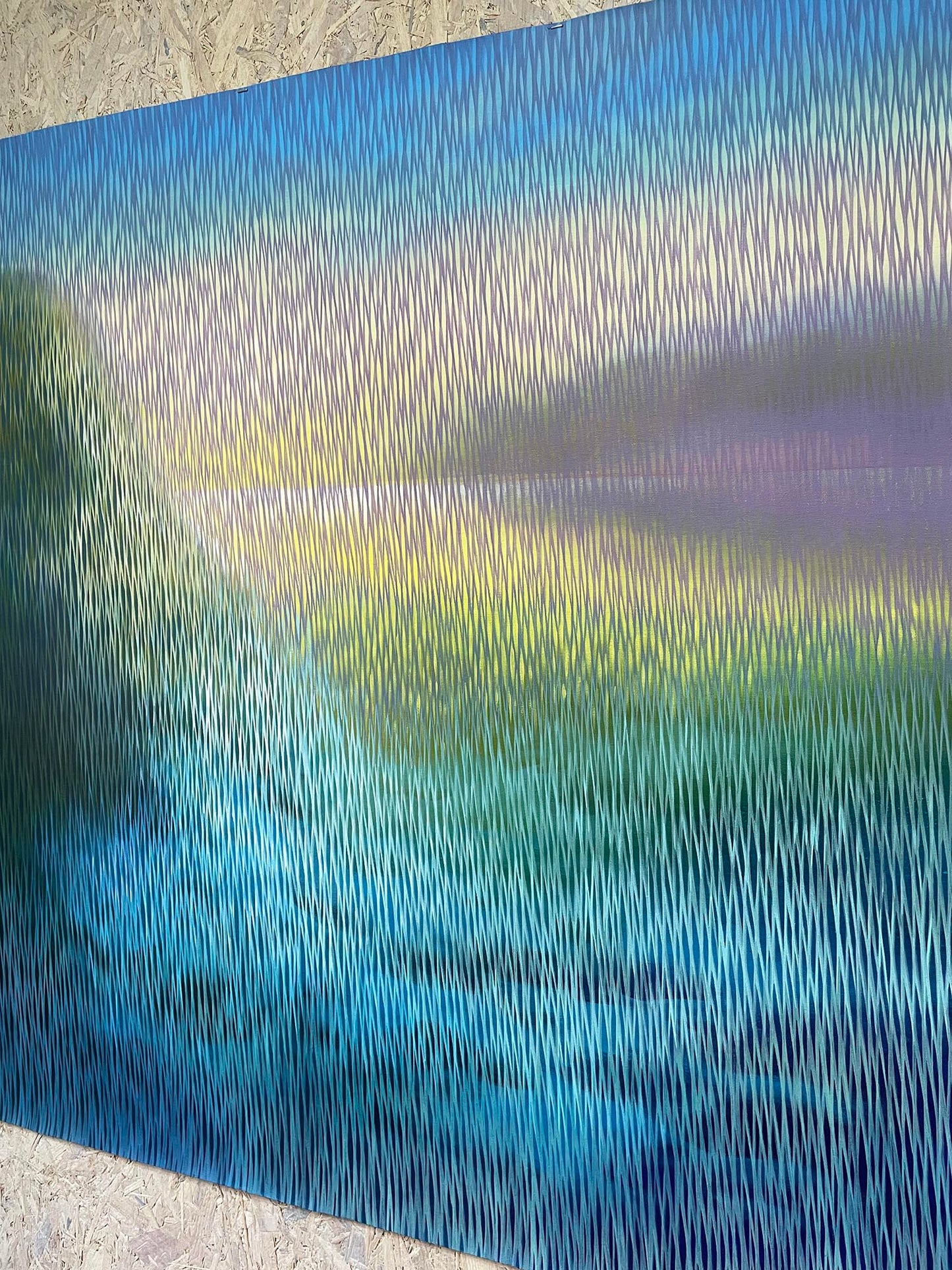 Abstract artwork with wavy lines in blue, green, and purple on a textured surface.