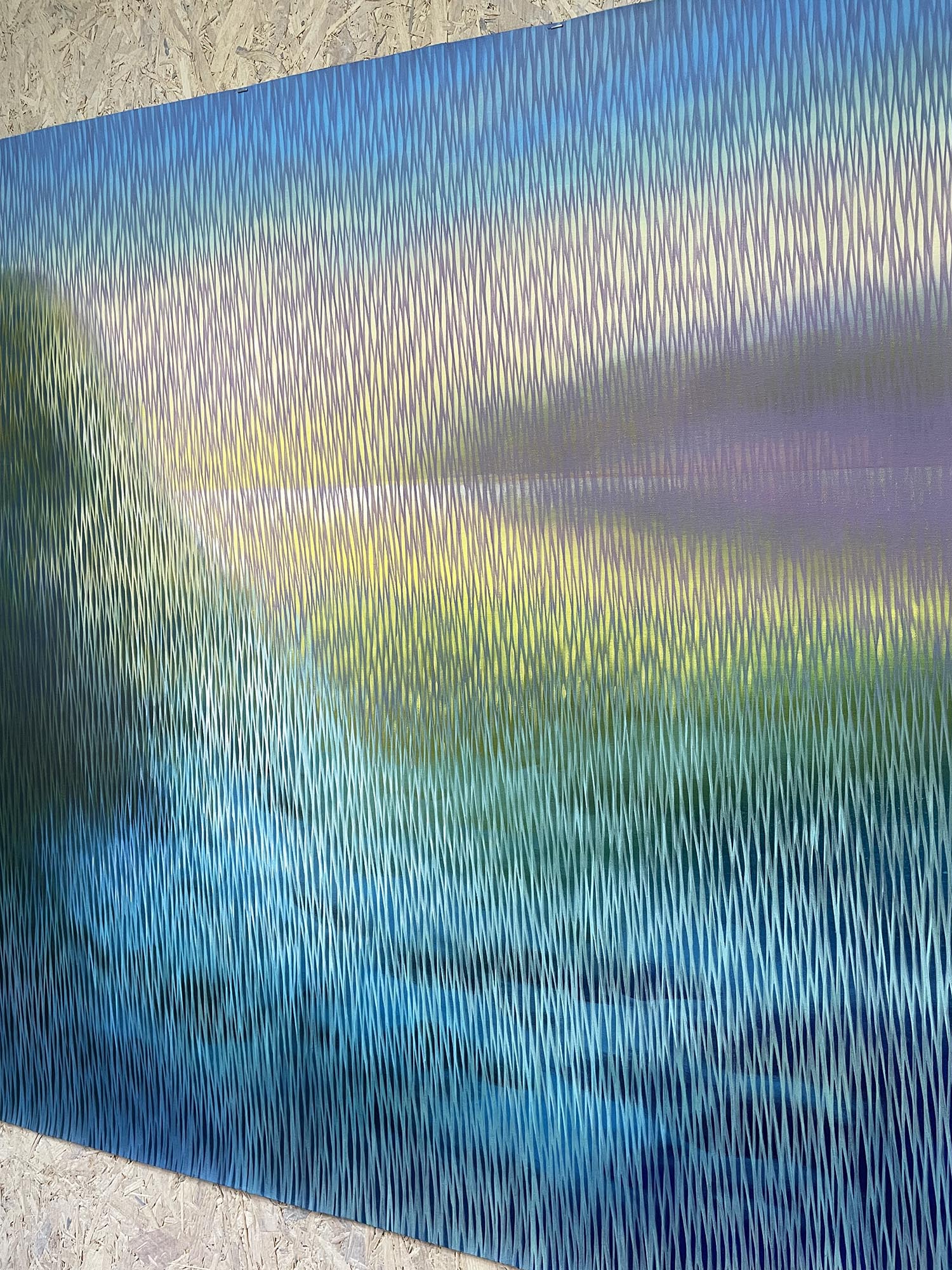 Abstract artwork with wavy lines in blue, green, and purple on a textured surface.