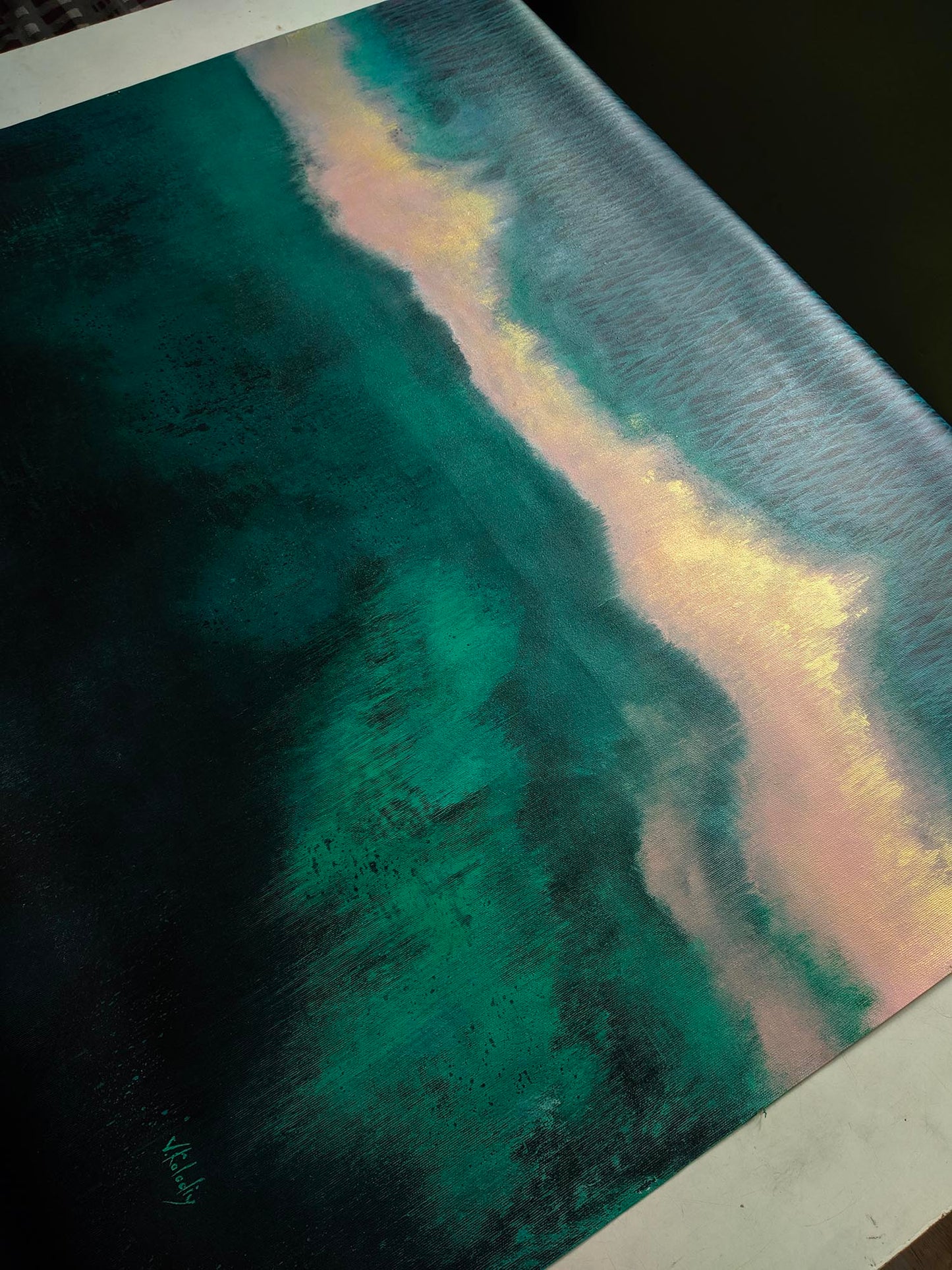 Abstract art with teal, pink, and black colors on a textured surface
