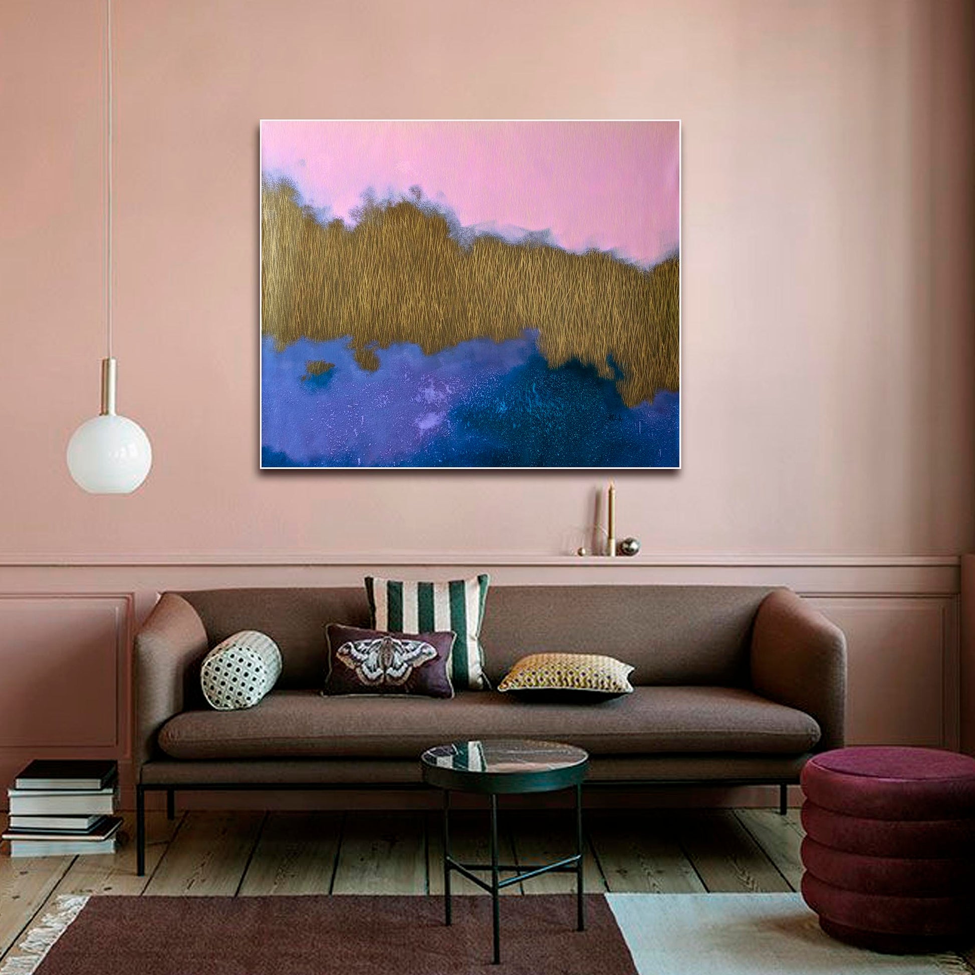 Modern living room with a brown sofa, abstract painting, and decorative pillows.