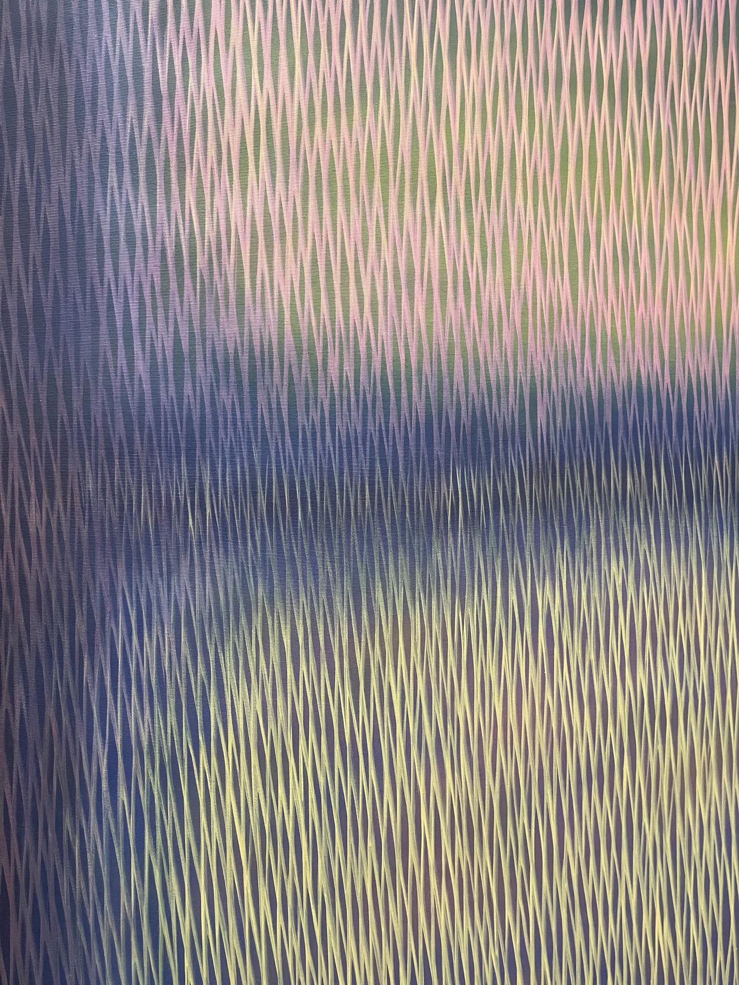 Abstract pattern with wavy lines in blue, green, and purple tones.